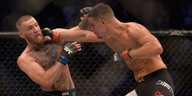 Nate Diaz punches Conor McGregor in their welterweight bout during the UFC 202 event. Photo / Getty Images