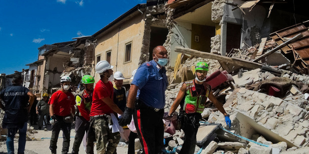 A victim is taken away in Amatrice. Photo / AP