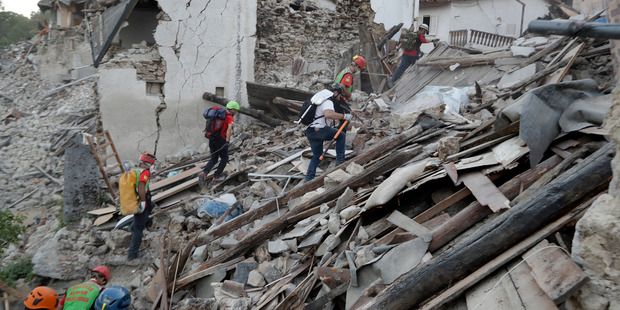 Rescuers search through debris following an earthquake in Pescara Del Tronto, Italy. Photo / AP