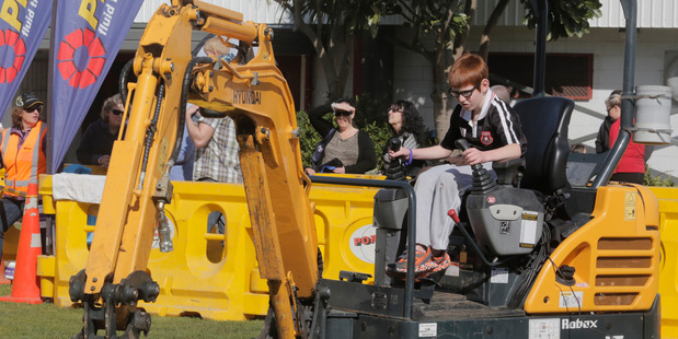 Liam Ramsey-Colgan tests his digger skills. Wanganui Chronicle photograph by Bevan Conley.