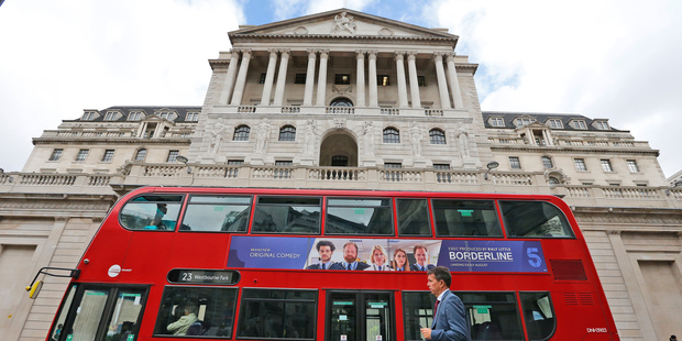 A London bus passes the Bank of England in London. Photo / AP