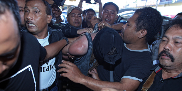 Indonesian police officers escort murder suspect David Taylor. Photo / AP