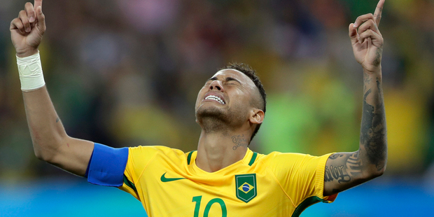 Brazil's Neymar weeps as he kneels down to celebrate after scoring the decisive penalty kick. Photo / AP