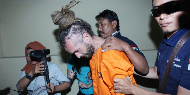 Indonesian police officers escort murder suspect David Taylor to an investigator's room at a local police station in Bali. Photo / AP