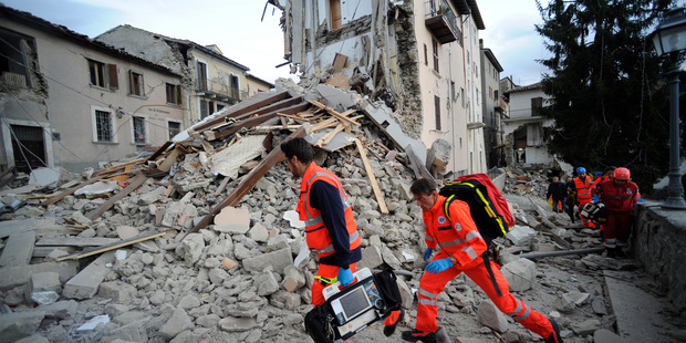 Rescuers search a crumbled building in Arcuata del Tronto, central Italy. Photo / AP