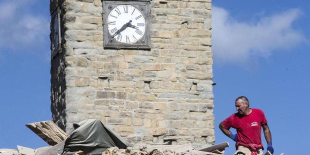 The clock of the Bell Tower of the Italian village of Amatrice is stopped at the time when an earthquake struck central Italy. Photo / AP