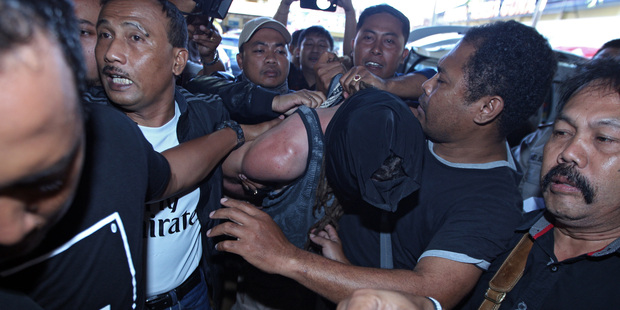 Indonesian police officers escort murder suspect David Taylor. Photo / AP