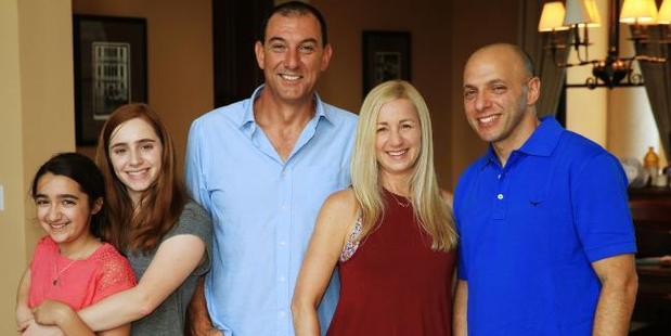 News Corp Australia photographer Nathan Edwards with Jen and her family after his 15-year search. Photo / News Corp Australia