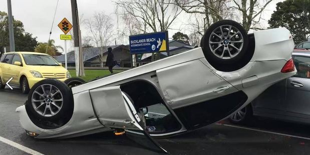 The driver of this car was treated by St John for minor injuries after it overturned outside Bucklands Beach Intermediate in Auckland this morning. Photo/Facebook