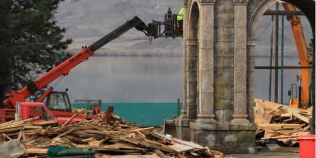 What was to be a Sea of Galilee fishing village and harbour at Falstone Camp is demolished by Paul Smith Earthmoving employees at Lake Benmore. Photo / Hamish MacLean, Otago Daily Times