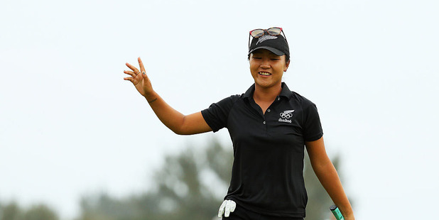 Lydia Ko celebrates after sinking a birdie putt on the 18th hole to secure an Olympic silver medal. Photo / Getty