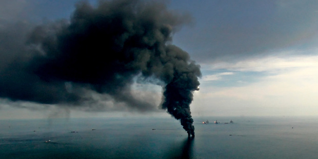 Smoke billows from controlled oil burns near the BP Deepwater Horizon oil spill. Photo / Derick E. Hingle