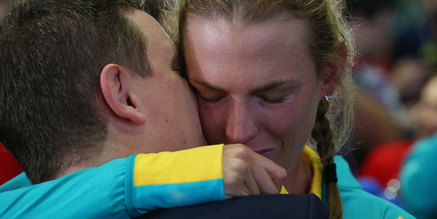 An athlete is embraced during the Welcome Home for Australian Olympic Games athletes at Sydney International Airport. photo / Getty