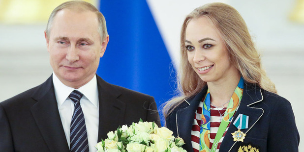 Russian President Vladimir Putin, left, poses with Russia's Olympic rhythmic gymnastics champion Anastasia Maximova. Photo / AP