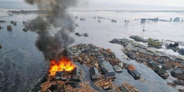Houses were swallowed by tsunami waves and burned in Natori, Miyagi Prefecture (state) after Japan was struck by a strong earthquake off its northeastern coast. Photo / AP