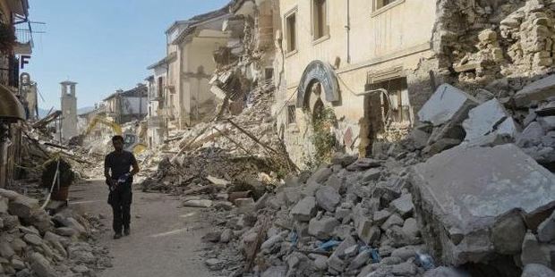 A man walks in a street in Amatrice, central Italy, where a 6.2 earthquake struck just after 3:30am. Photo / AP