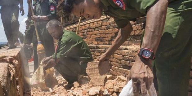 Using brooms and their hands, soldiers and residents of the ancient Myanmar city famous for its historic Buddhist pagodas began cleaning up the debris a powerful earthquake shook the region. Photo: AP