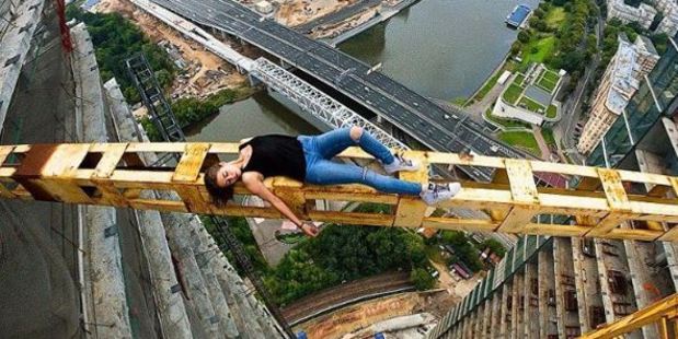Here, clad in jeans, she takes a rest on a stretch of scafolding overlooking a very long drop down to the city of Moscow. Photo / Angela Nikolau Instagram