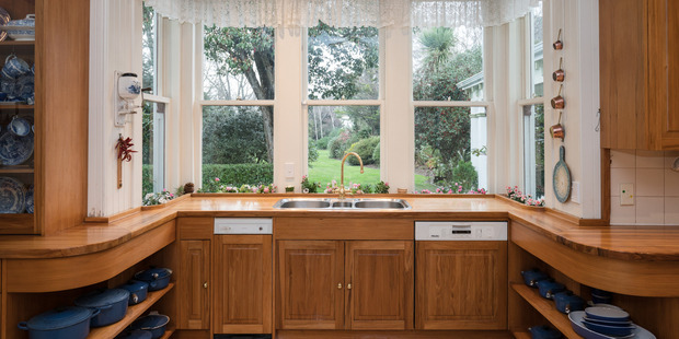 A country style kitchen looks out to the gardens. Photo / Supplied