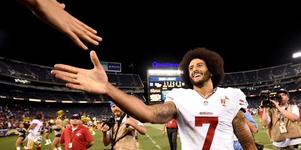 Colin Kaepernick was still popular with fans after yesterday's game, despite not standing for the national anthem. Photo / AP