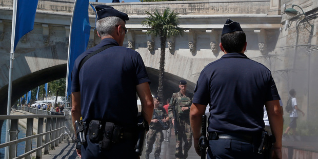 French Police officers and soldiers patrol along the Seine River at Paris Plage in Paris. Photo / AP