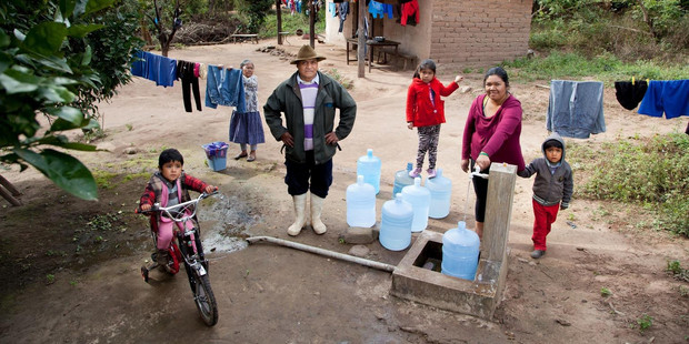Rene Visalla (third from left) says running water and a toilet have made life much safer for his family as they often encountered snakes while relieving themselves in the bush. Photo / Unicef
