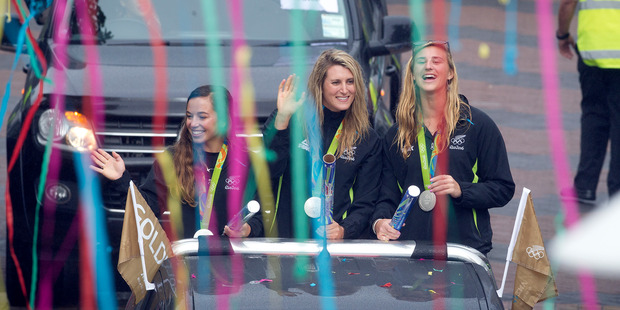 Alex Maloney, Luuka Jones, and Molly Meech enjoy the Tauranga Olympic parade. PHOTO/ANDREW WARNER