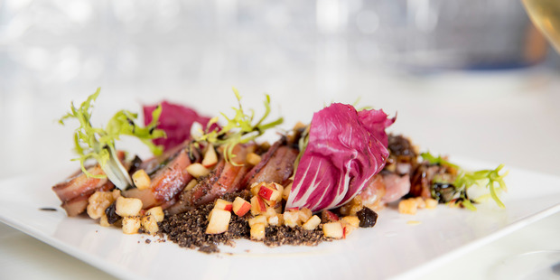 Pork loin with lemongrass glaze, coffee soil & apple, prune, walnut salad. Photo / Michael Craig