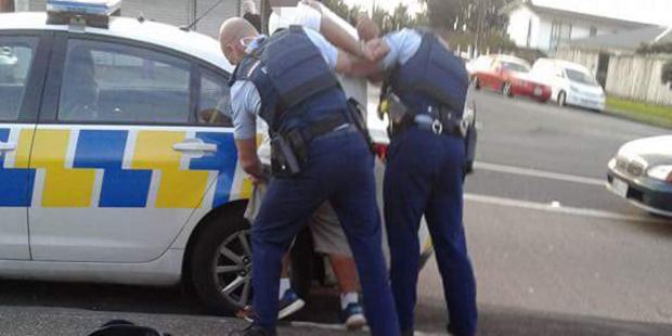 Police detain a suspect following a brawl at the Mangere branch at KFC. Photo / via Facebook
