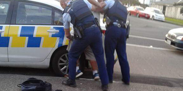 Police detain a suspect following a brawl at the Mangere branch of KFC. Photo / Supplied