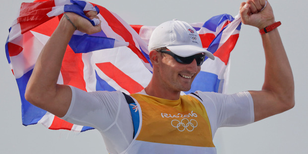 Britain's Giles Scott celebrates winning the men's Finn sailing race at the 2016 Olympics. Photo / AP