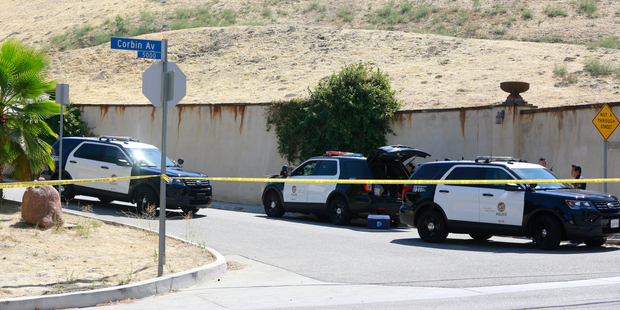 Los Angeles Police patrol the entrance to the street of singer Chris Brown's home in the Tarzana neighborhood. Photo / AP