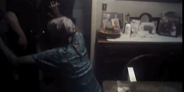 After she was pepper sprayed, the elderly black woman turned her head, raised her arms and fell to the ground. Photo / AP