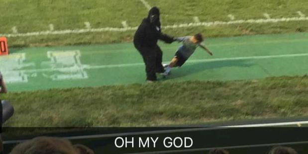 A man in a gorilla costume swings a child by the arm at a Cincinnati school. Photo / Imgur, TheAmazingSky