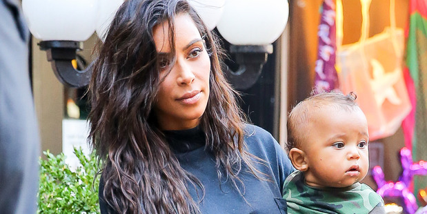 Kim Kardashian carrying Saint West and North while they where leaving Serendipity 3 restaurant in New York. Photo / Splash News Australia