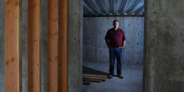 Chris Walsh of Revolutionary Realty stands in the cellar of an unfinished home for sale in Spirit Lake, Idaho. Photo / The Washington Post