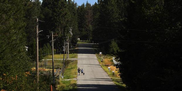 Don and Jonna Bradway go for a walk with their dog, Moose, near their home in Hayden, Idaho. Photo / The Washington Post