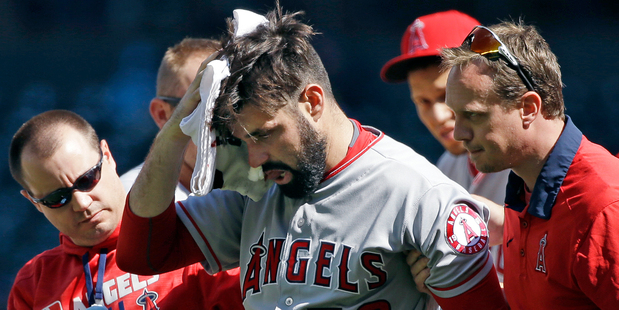Los Angeles Angels starting pitcher Matt Shoemaker is assisted off the field. Photo / AP