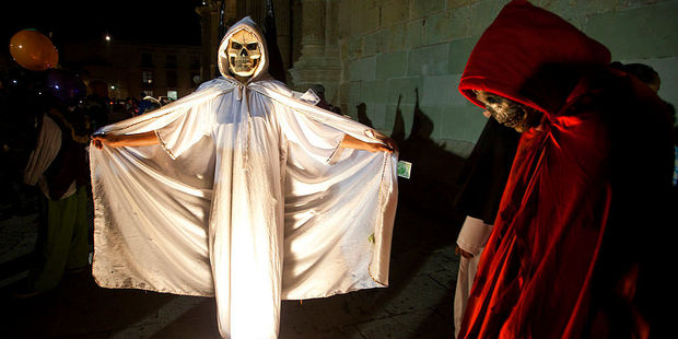 People in ghoulish costumes participate in a parade for the Day of the Dead in Oaxaca. Photo / Getty Images