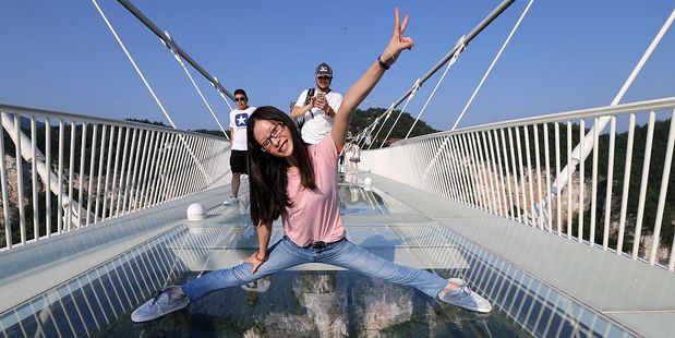 A woman poses on the bridge before it was forced to close. Photo / Getty Images
