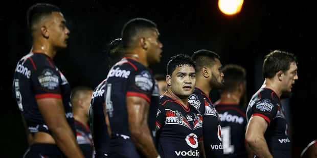 Dejected Warriors players after conceding another try. Photo / Getty