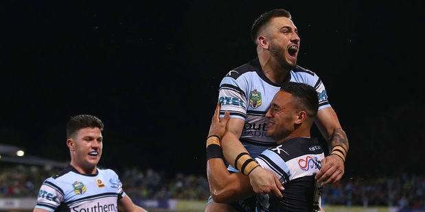Chad Townsend of the Sharks watches on as Jack Bird and Valentine Holmes celebrate Holmes scoring a try. Photo / Getty