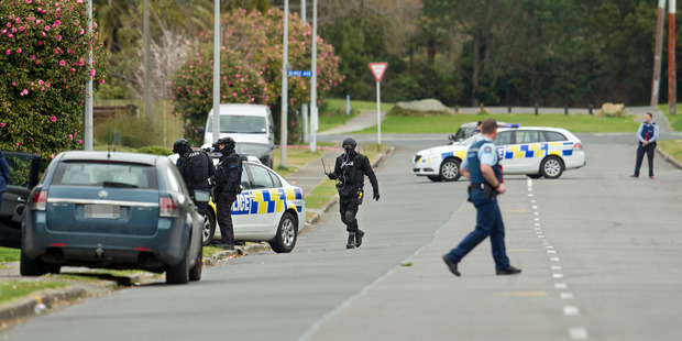 Members of the Rotorua police Armed Offenders Squad swooped on the McIntyre Ave house about 12.30pm yesterday. PHOTO/BEN FRASER