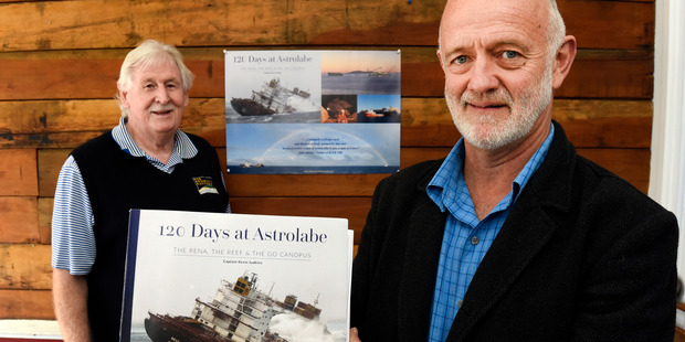 Captain Kevin Judkins and his book offering an eye witness view of the Rena salvage. Also pictured is Grumpy's Gallery owner Bob Ricketts. Picture/George Novak