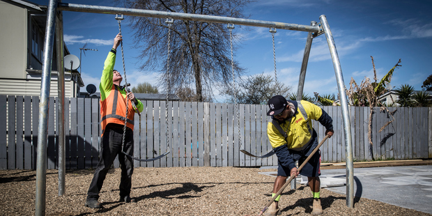 Workman install new swings at Delphine Reserve. Photo / Michael Craig
