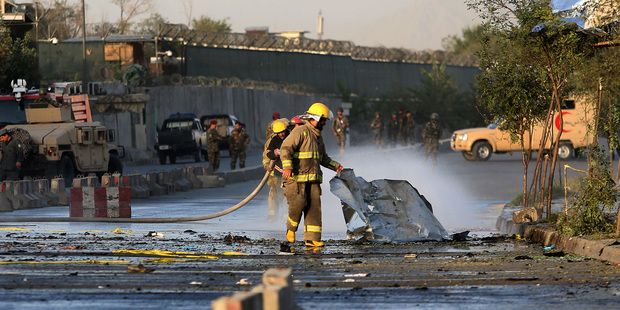 Afghan firefighters at the site of suicide attack near the Afghan Defense Ministry in Kabul, Afghanistan. Photo / AP
