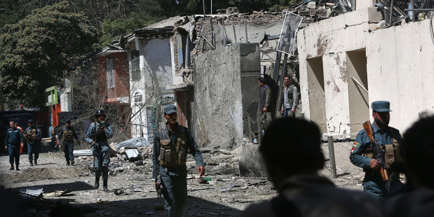 Afghan security forces in Kabul where militants stormed a building housing an international aid organisation. Photo / AP