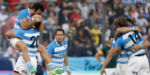 Argentina's Los Pumas players celebrate after defeating South Africa 26-24. Photo / AP
