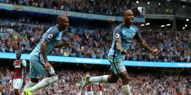 Manchester City's Raheem Sterling, right, celebrates with team-mate Fernandinho. Photo / AP.
