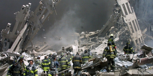 Firefighters make their way through the rubble after two airliners, below, crashed into the World Trade Centre on September 11, 2001.